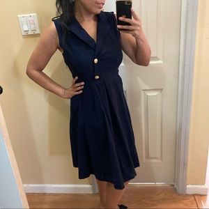 Navy blue dress with gold buttons and pockets